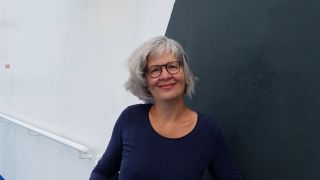 Professional headshot of Susanne Breier smiling warmly.